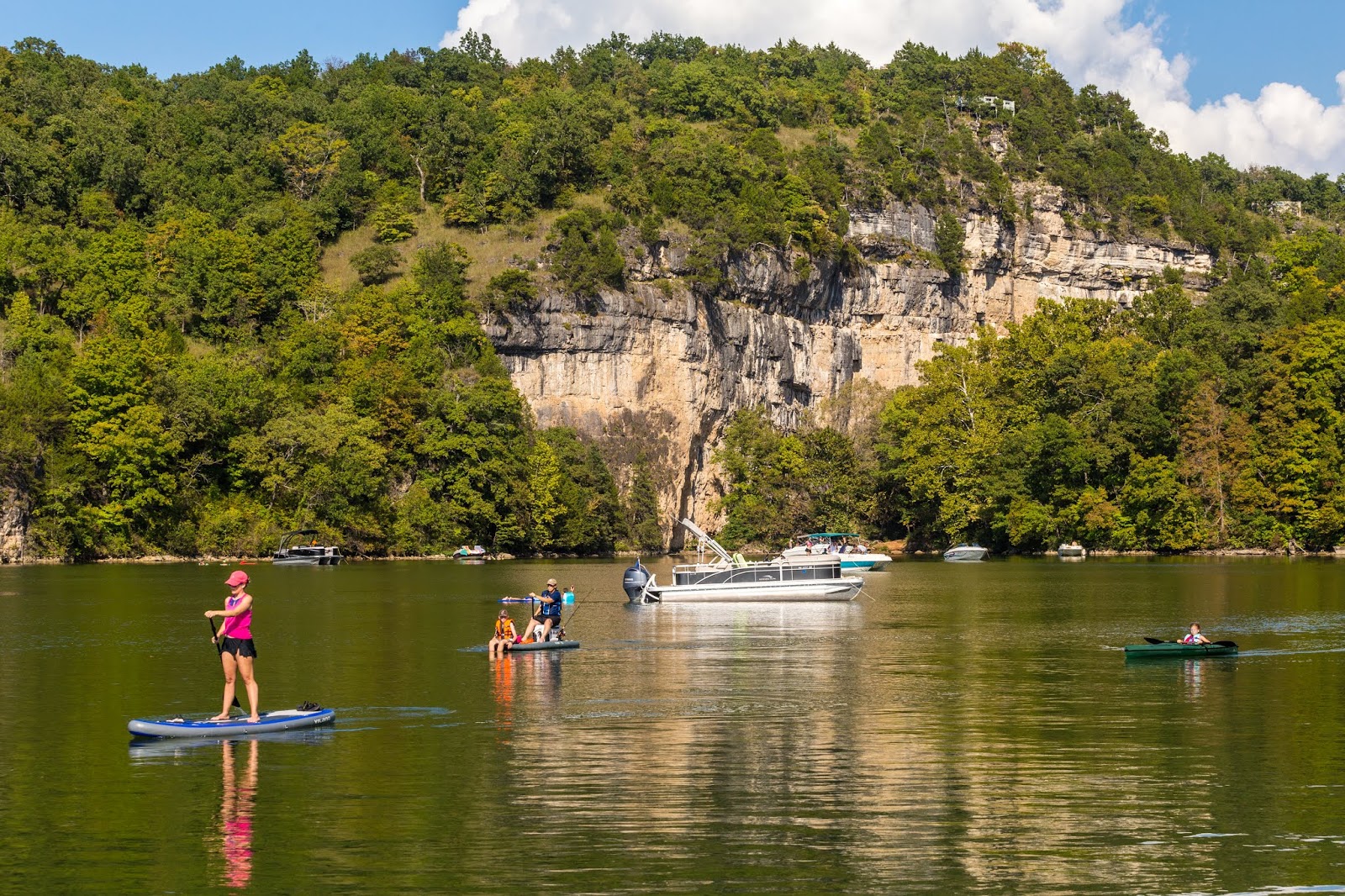 Lake of the Ozarks, families on the lake with boats, canoes, paddleboards and more. 